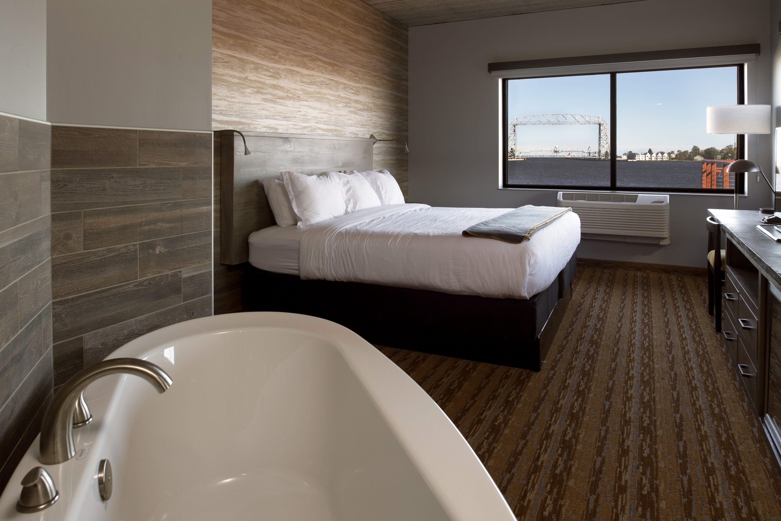 The guest rooms pair sleek furniture with modern yet rustic wall finishes.
