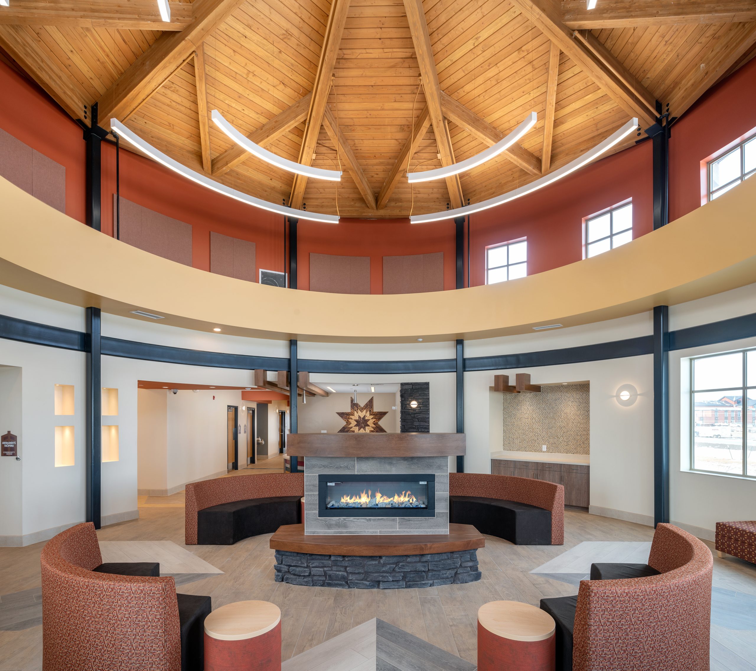 Central fireplace welcomes guests to the light filled lobby.