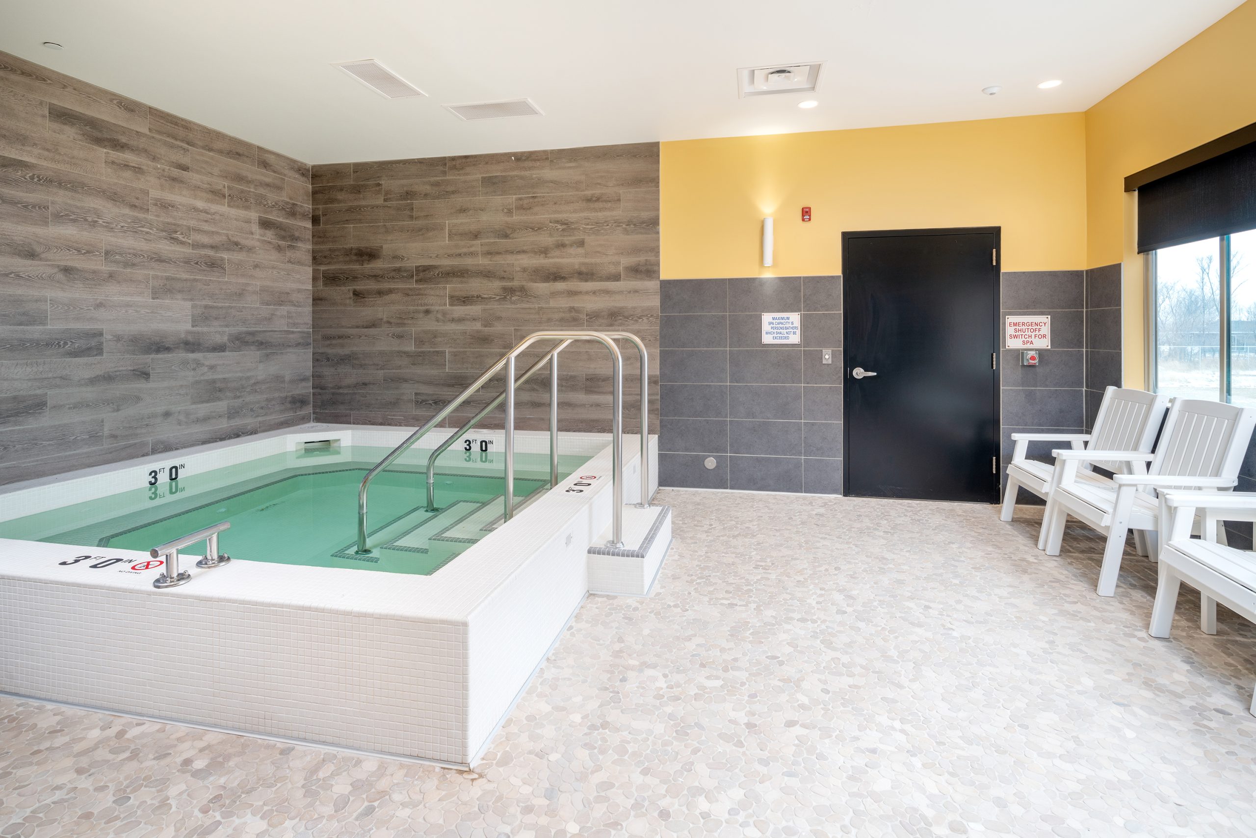 Hydro-therapy room has ease of access to a spa hot tub.