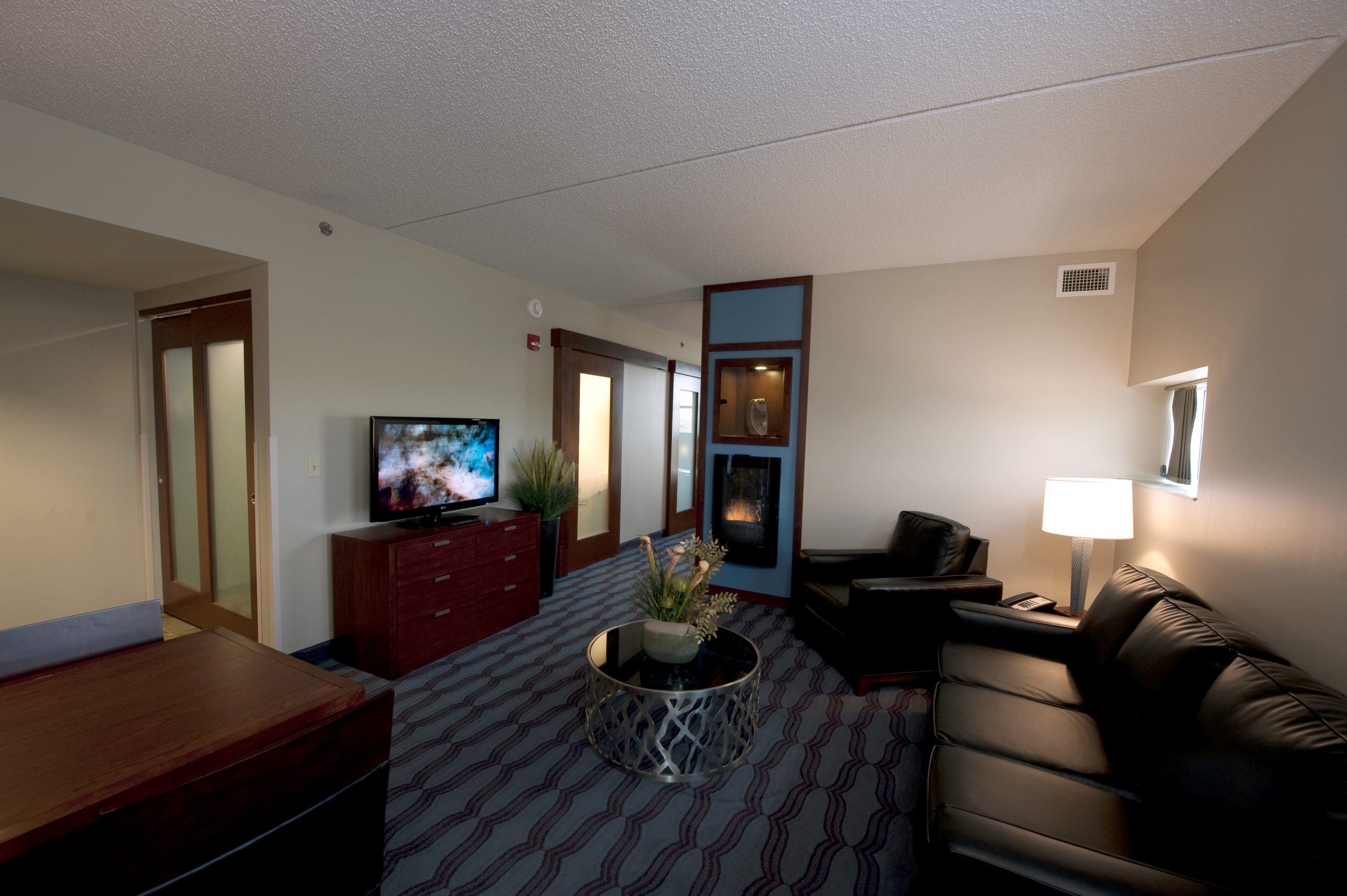 Suites on the upper floors include fireplaces, wet bar, dual bathrooms, and comfortable living room and bedroom spaces.