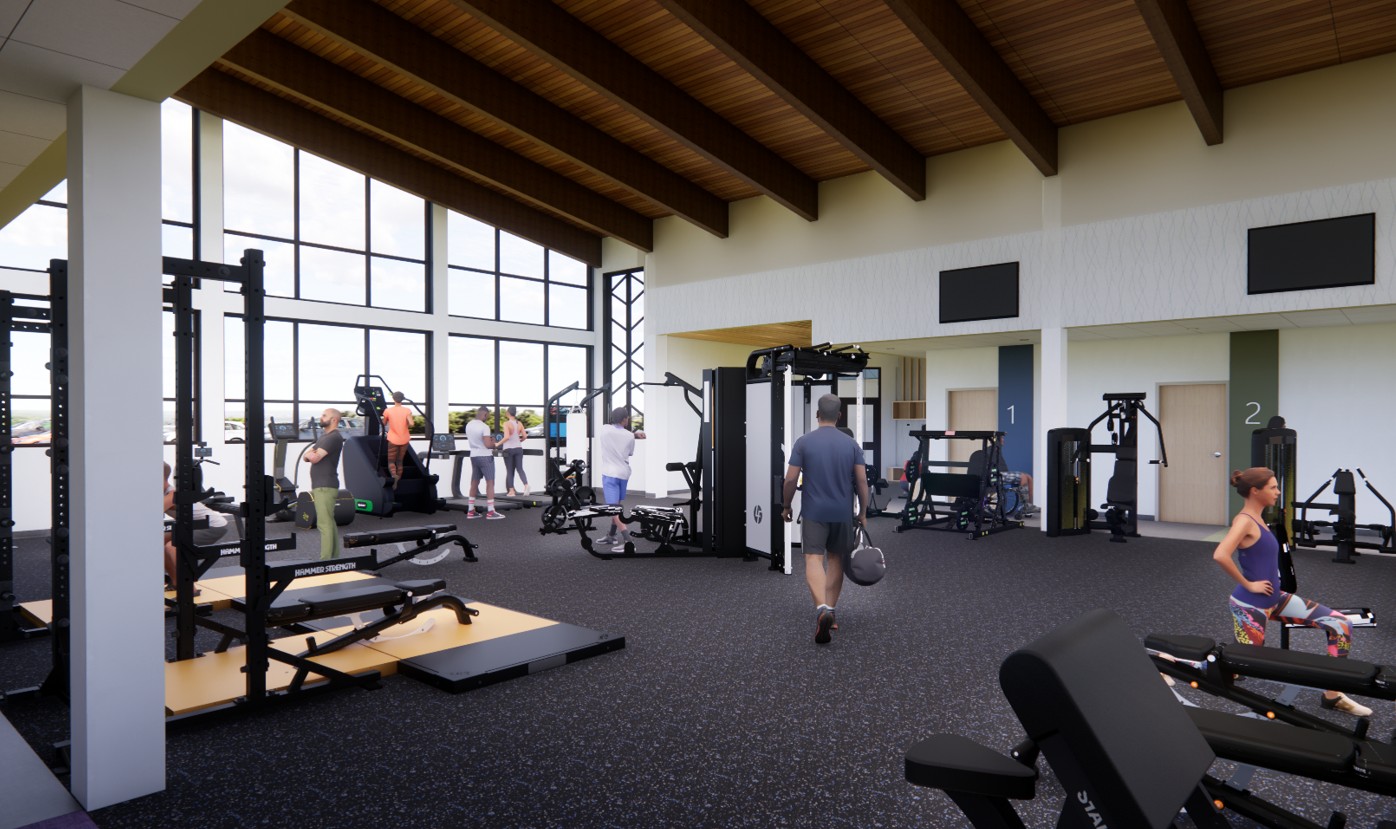 A spacious gym with large windows, wooden ceiling, and various exercise equipment. Several people are working out, lifting weights, and using machines. The room is bright and modern.