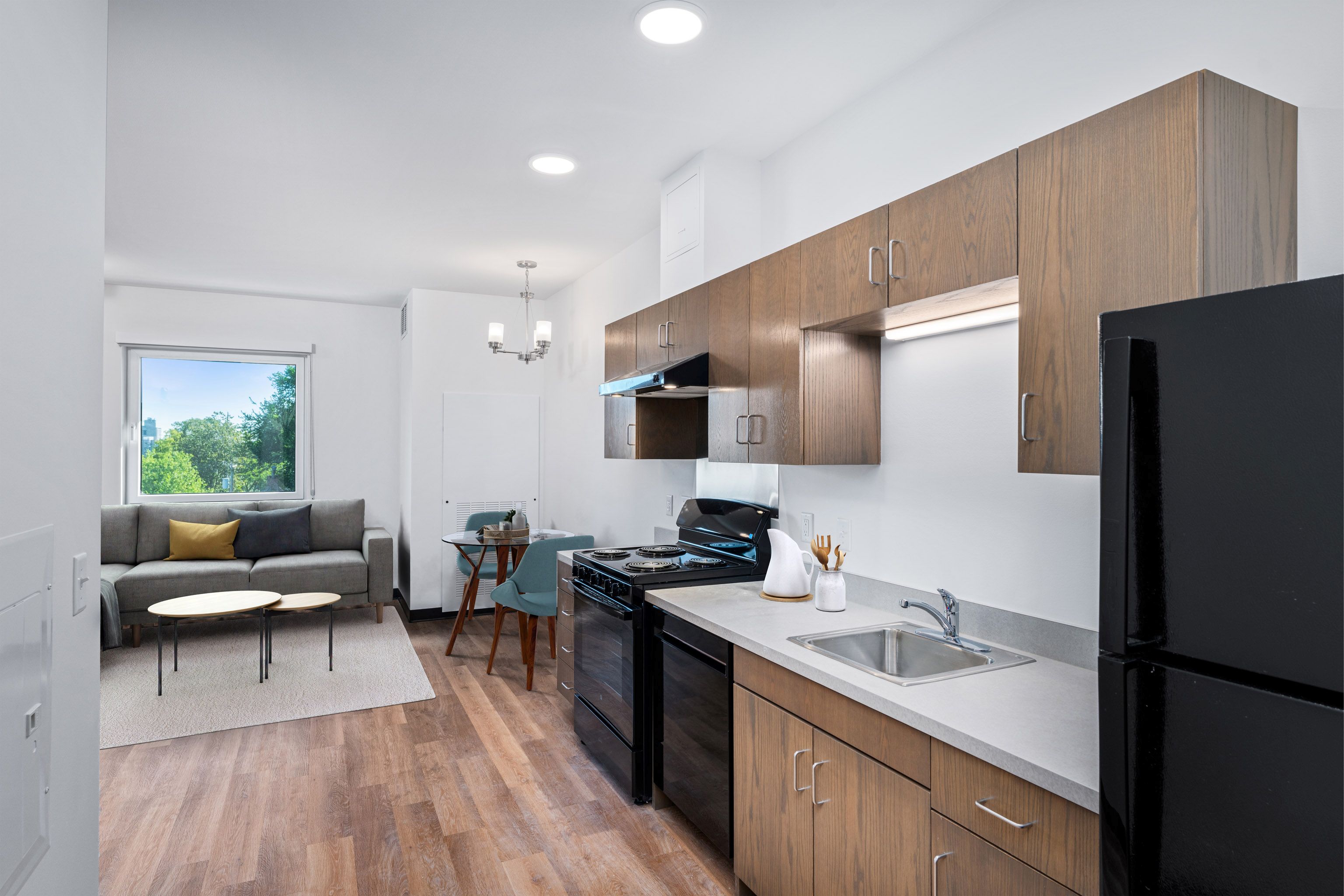 The building encompasses three residential levels, offering 36 units of affordable housing.